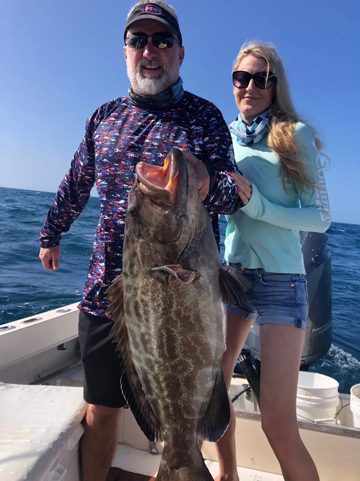 Angler showing off a black grouper on deck