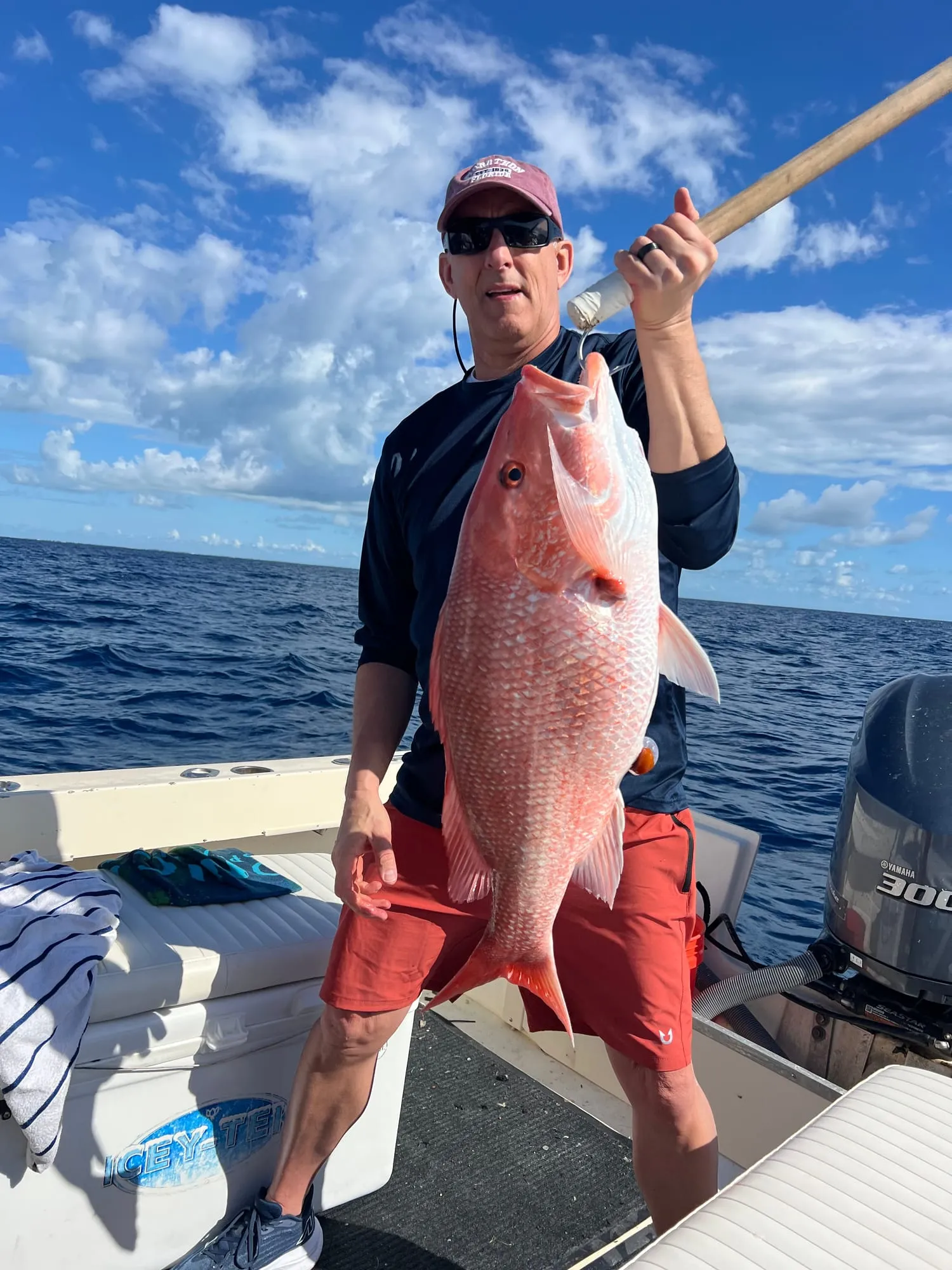Smiling angler holding a red snapper